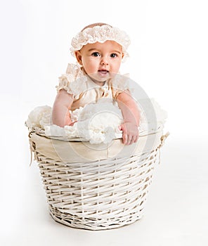 Cute little girl in a wicker basket