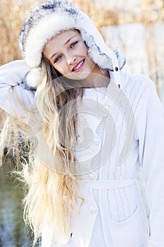 Cute little girl in winter clothes outdoors