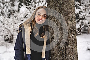 cute Little girl in winter snow forest