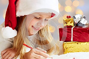 Cute little girl writes letter to Santa Claus