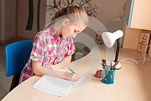 Cute little girl writing her homework