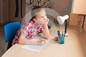 Cute little girl writing her homework