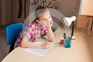 Cute little girl writing her homework