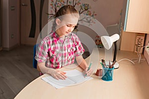 Cute little girl writing her homework