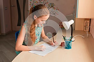 Cute little girl writing her homework