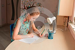 Cute little girl writing her homework