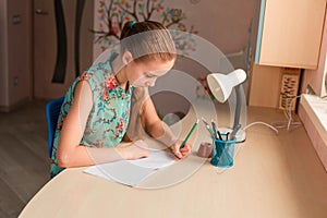 Cute little girl writing her homework