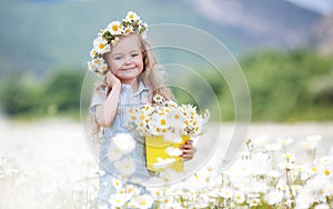 Cute little girl with yellow bucket white daisies