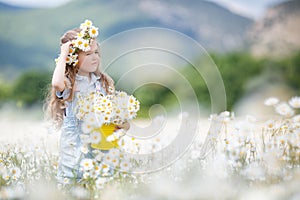 Cute little girl with yellow bucket white daisies