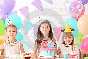 Cute little girls celebrating Birthday at home