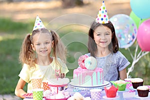 Cute little girls celebrating Birthday outdoors