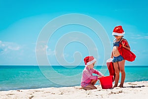 Cute little girls celebrating christmas on tropical beach