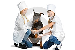 Cute little girls dressed like doctor treated dog