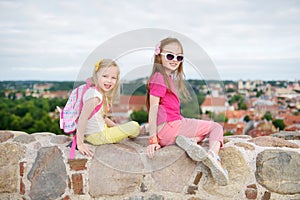 Cute little girls enjoying a view of Vilnius city from the Gediminas hill