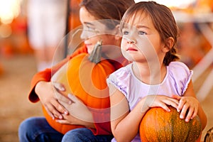 Cute Little Girls Holding Their Pumpkins At A Pump