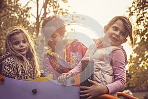 Three little friends girls in palyground. photo