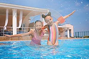 Cute little girls in swimming pool at water park