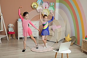 Cute little girls taking dance class at home