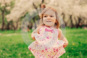 Cute little happy toddler girl portrait walking in spring or summer park