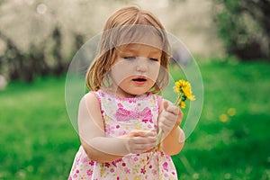 Cute little happy toddler girl portrait walking in spring or summer park