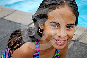 Cute little Hispanic girl by the pool
