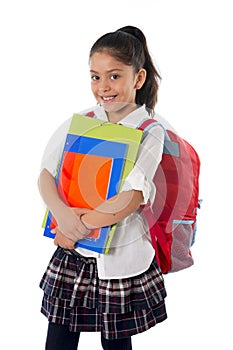 Cute little hispanic school girl carrying schoolbag backpack and books smiling