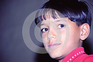 Cute little indian asian boy smiling wearing red shirt