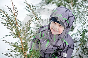 Cute little kid boy in colorful winter clothes laying down on . Active outdoors leisure with children in . Happy child.