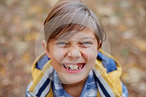 Cute little kid boy enjoying in autumn park.