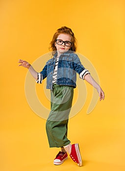 cute little kid in eyeglasses dancing