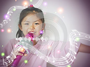 Cute little kid girl 5 years old sing with lights and melodies. Childhood lifestyle concept. A girl enjoys singing a song in