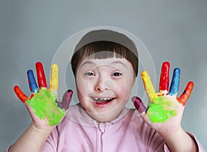 Cute little kid with painted hands. Isolated on grey background