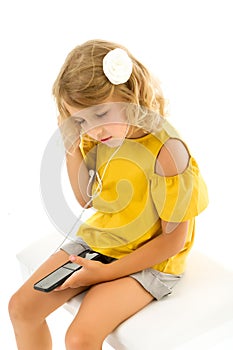 Cute little kid wearing headphones listening to music. Kid listening to music. Music recommended based on initial