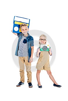 cute little kids with camera and tape recorder smiling at camera