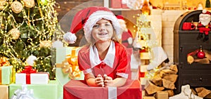 Cute little kids celebrating Christmas. Christmas kids celebration holiday. Happy cute child in Santa hat with present