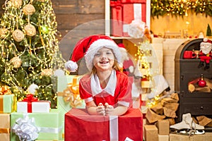 Cute little kids celebrating Christmas. Christmas Celebration holiday. Happy cute child in Santa hat with present have a