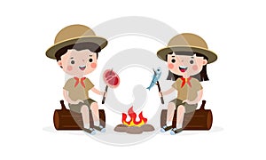 Cute little kids sitting on log and Roasting Fish and fish on campfire, boy scout or girl scout honor uniform, kids summer camp,