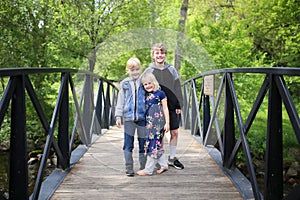 Cute Little Kids Standing on Bridge Smiling