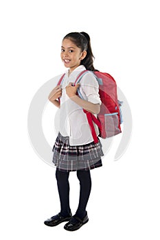 Cute little latin school girl carrying schoolbag backpack and books smiling