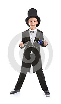 Cute little magician showing trick with rings on white background
