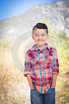 Cute Little Mixed Race Young Boy Standing Outdoors.