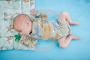 Cute little peaceful baby calm sleeps soundly in his crib in a bright room