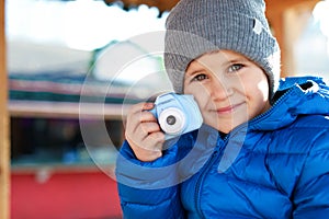 Cute little photographer with toy camera