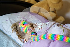 Cute little preschhol girl after sleeping in bed. Happy joyful smiling child wake up in the morning, healthy sleep of