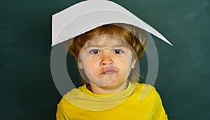 Cute little preschool kid boy in a classroom. Classroom. Schoolkid or preschooler learn. September 1. Learning concept