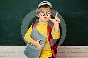 Cute little preschool kid boy in a classroom. Private school. Ready for school. Educational process. Funny little boy