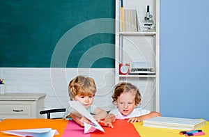 Cute little preschool kids boy pupils in classroom. School little kids ready to study. Concept of education and reading