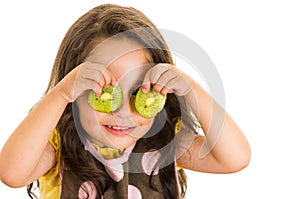 Cute little preschooler girl holding kiwi slices