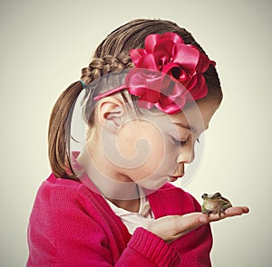 Cute Little Princess kissing a frog