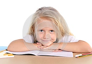 Cute little school girl happy on desk leaning in relax on book